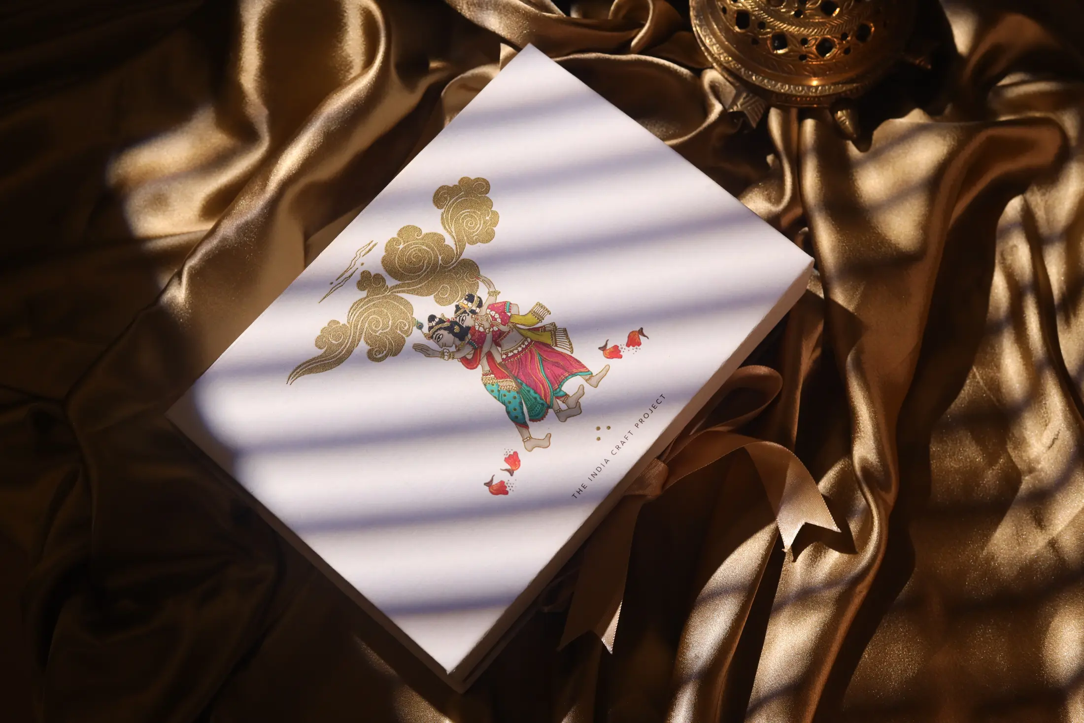 Luxury illustrated gift box photographed on bronze satin