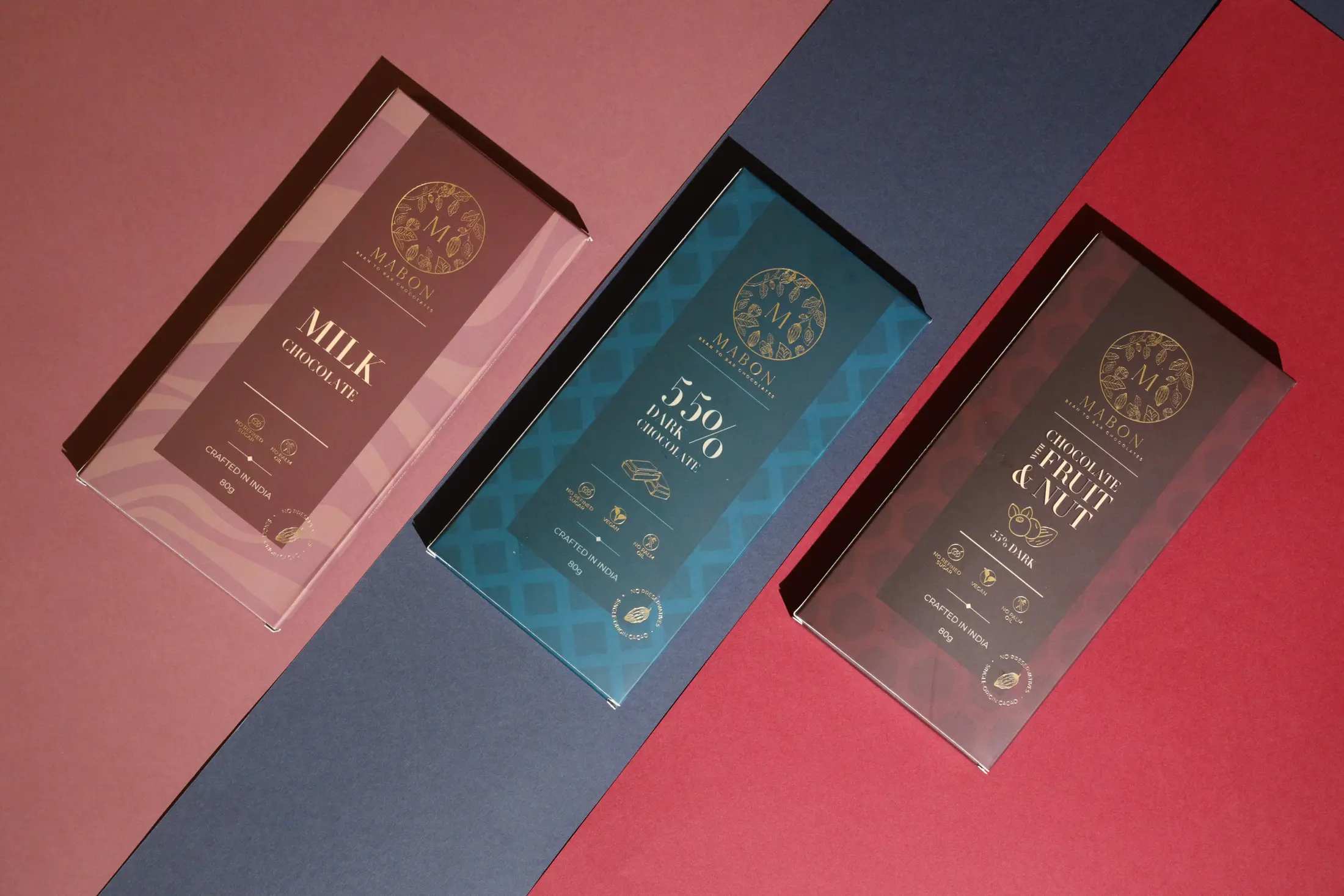 Premium chocolate cartons arranged on a bold colour-blocked background