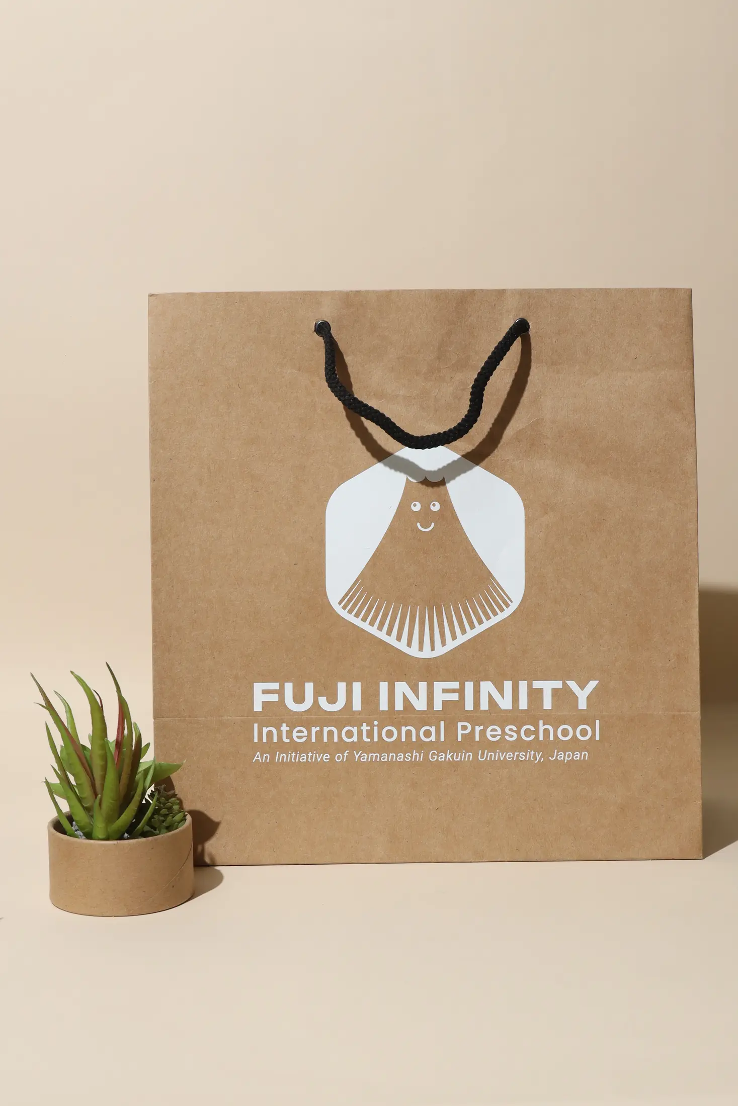 Custom kraft paper bag with white graphic print and black handles