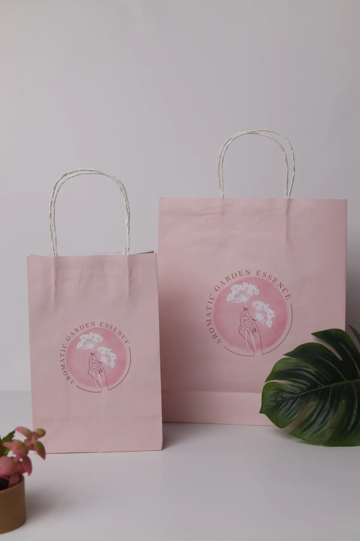 Set of soft pink custom paper bags with printed branding