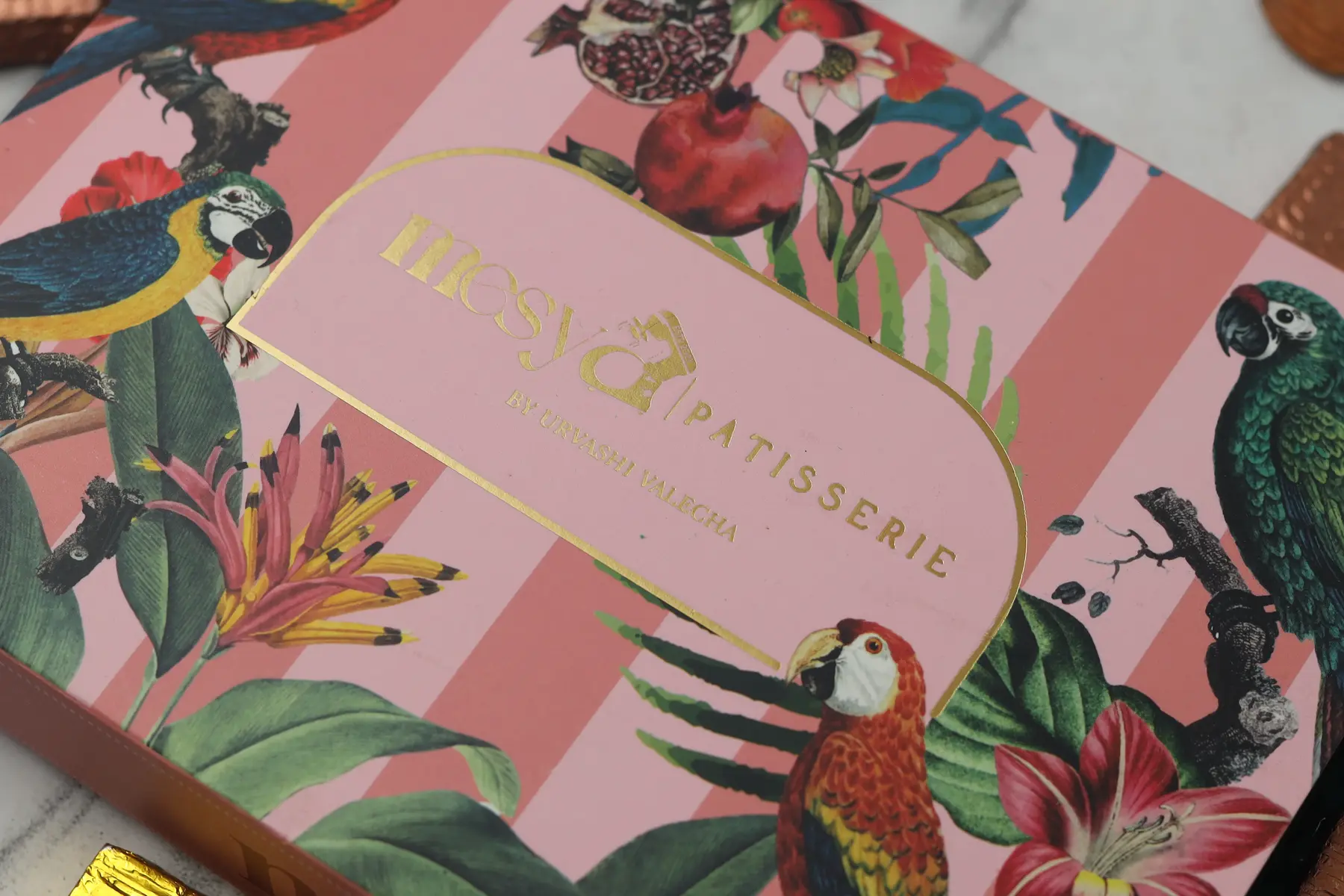 Pink botanical patisserie gift box with gold-foil title detail
