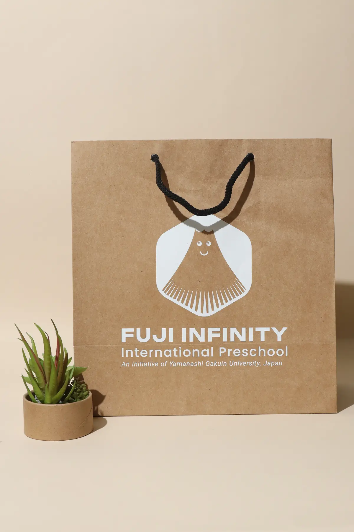 Kraft Fuji Infinity paper bag with white and gold print